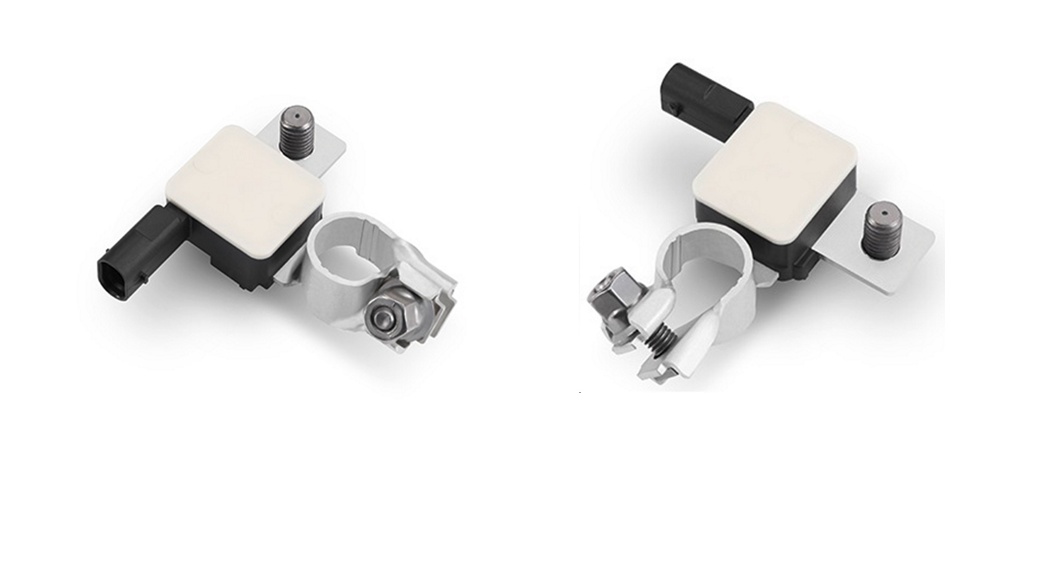 Two identical rectangular electronic components with white tops and black bases, each attached to a metallic clamp. The clamps are fastened with screws and bolts. Both components are viewed from different angles, showing the details of the clamps and connectors.